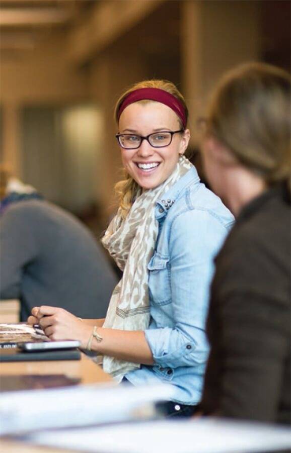 student smiling in conversation